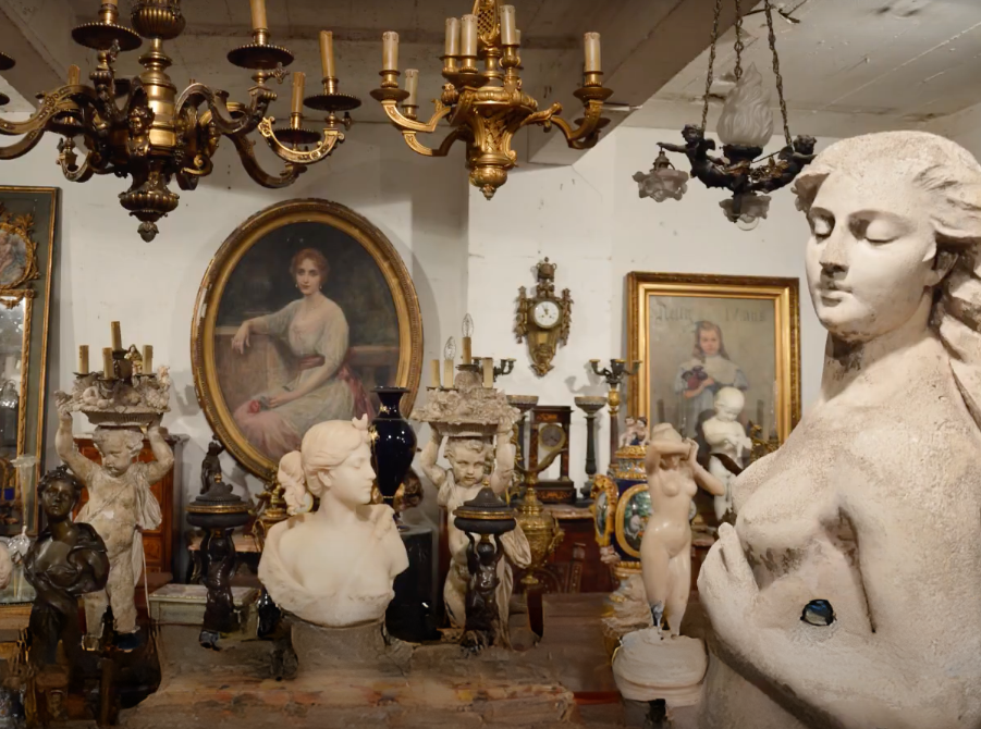Gilded chandeliers and marble busts